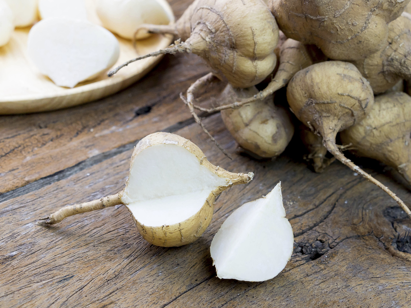 fresh cut jicama on wooden board