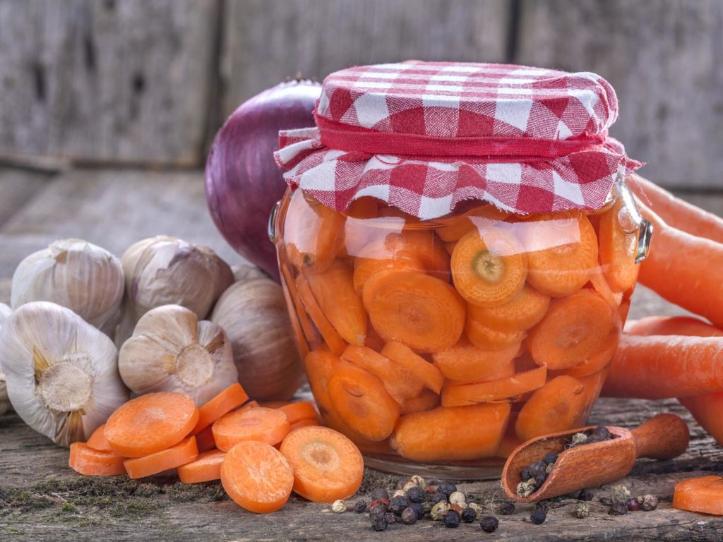 canned fresh domestic carrot in a jar on an old rustic table