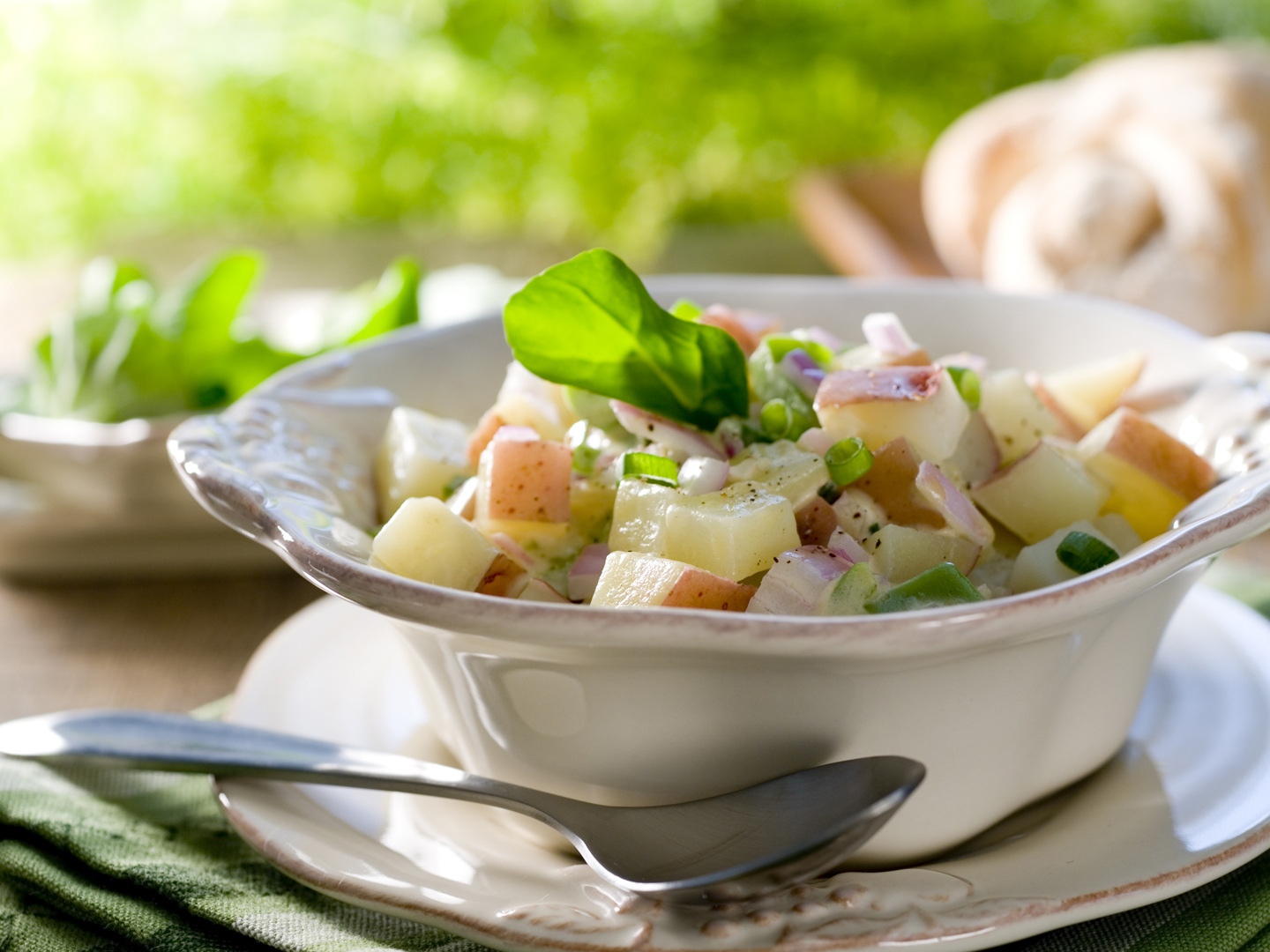 Closeup of a red potato salad. Selective focus; shallow depth of field.