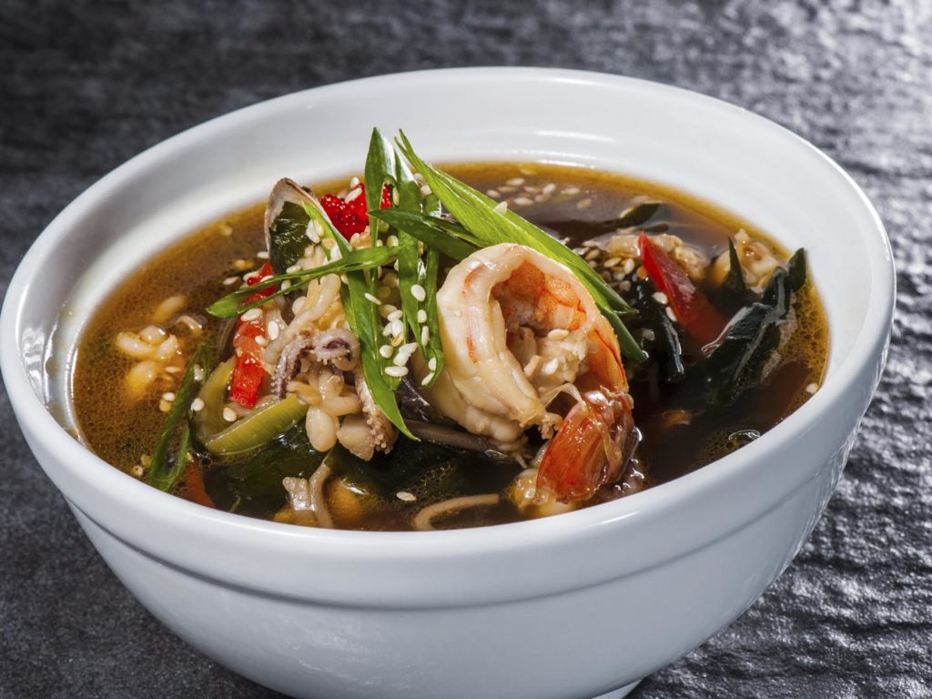 Traditional japanese soup with seafood, seaweeds and prawns