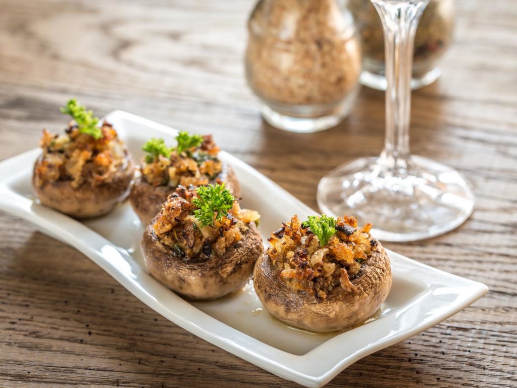 Mushrooms' caps stuffed with mixture of cheese, onion, breadcrumbs and butter