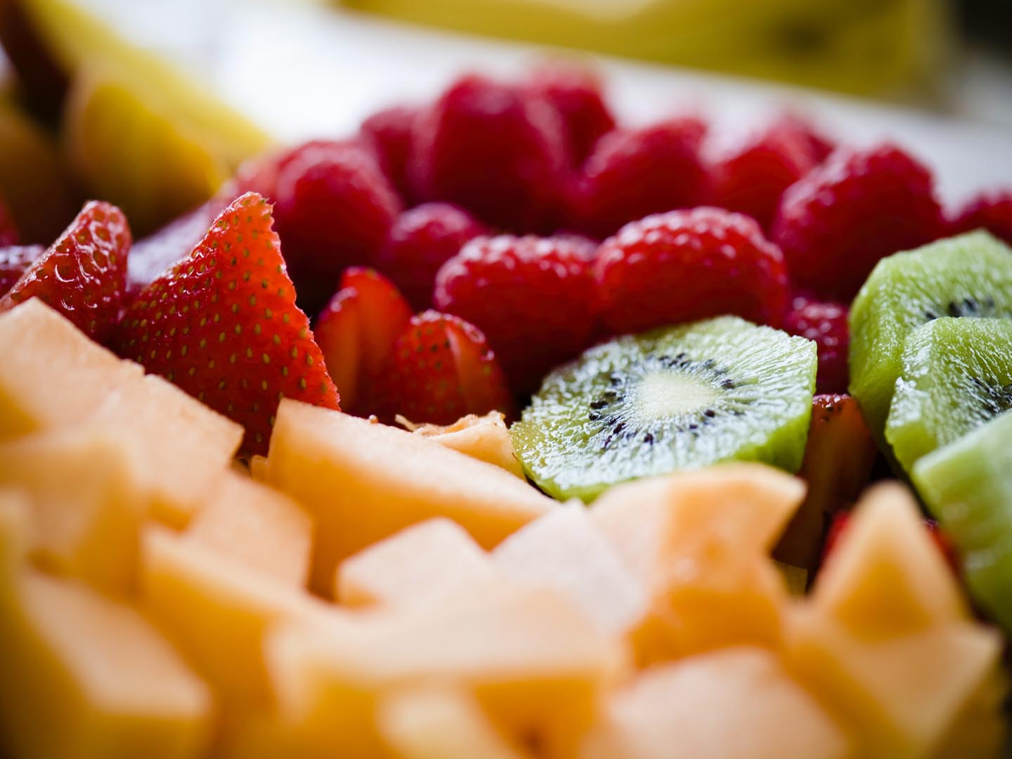 Berries Melon and Kiwi Fruit Tray. Closeup detail of fresh healthy fruit using very selective focus and extreme shallow depth of field. Converted from 14-bit RAW file. ProPhoto RGB color space.