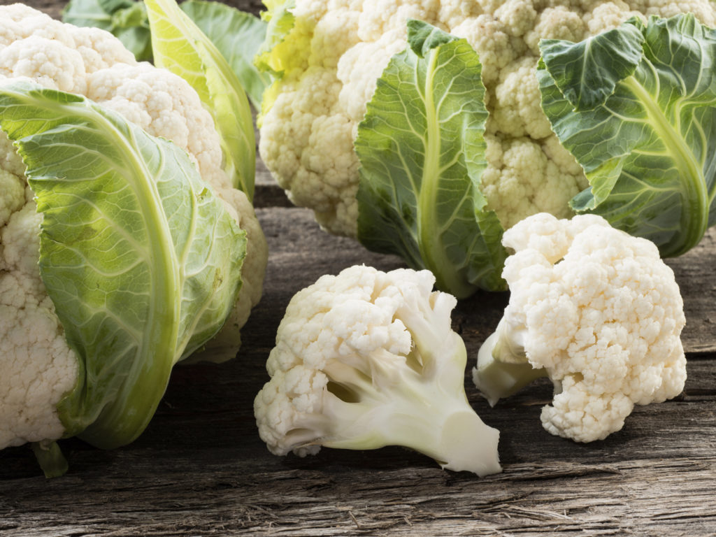 Organic cauliflower on wooden background