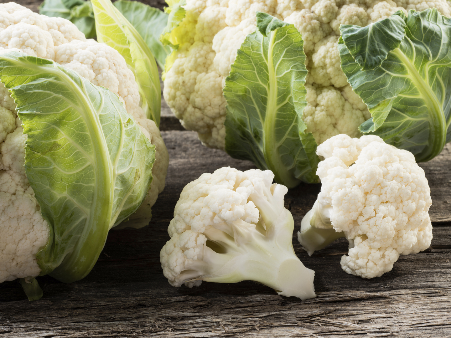 Organic cauliflower on wooden background