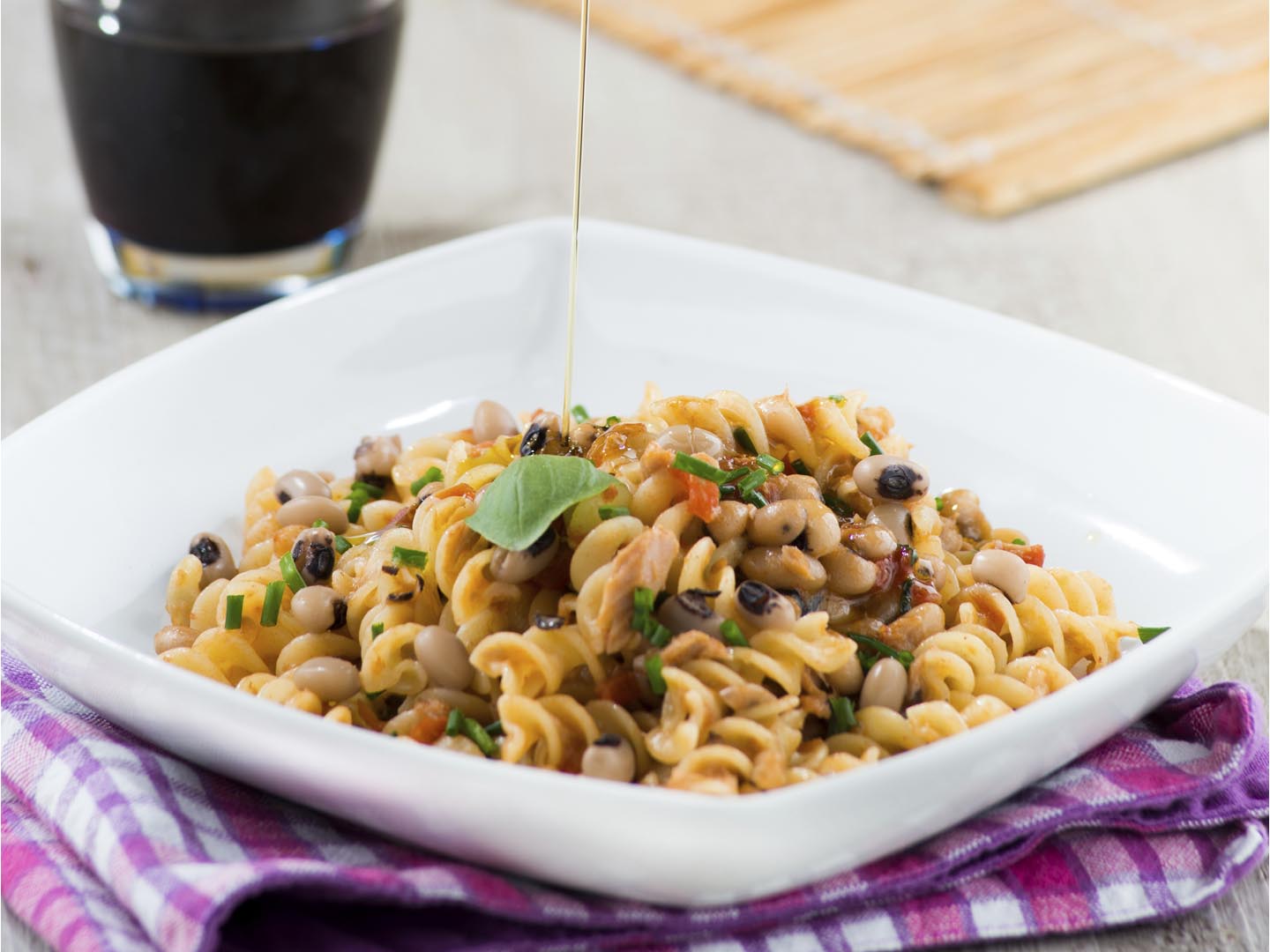 fusilli pasta with beans and tomato on a plate