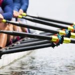 Close up of a men&#039;s quadruple skulls rowing team, seconds after the start of their race