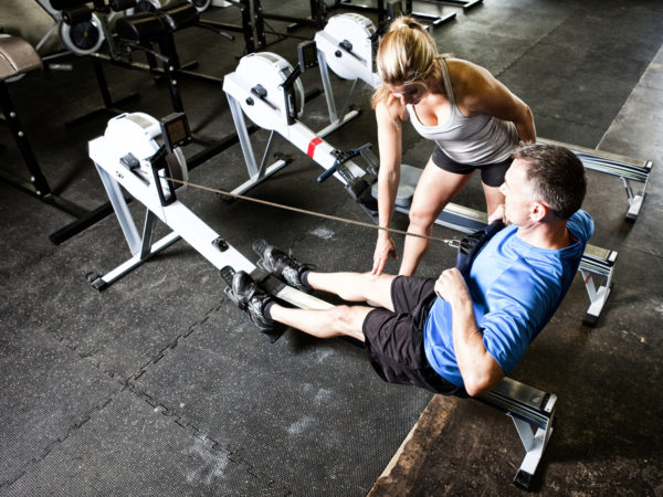 Personal trainer working with her client at a gym gym.