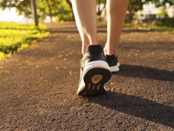 Close up woman walking on a path. Fitness concept.