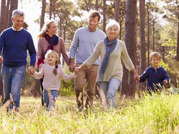 Happy multi-generation family walking in the countryside