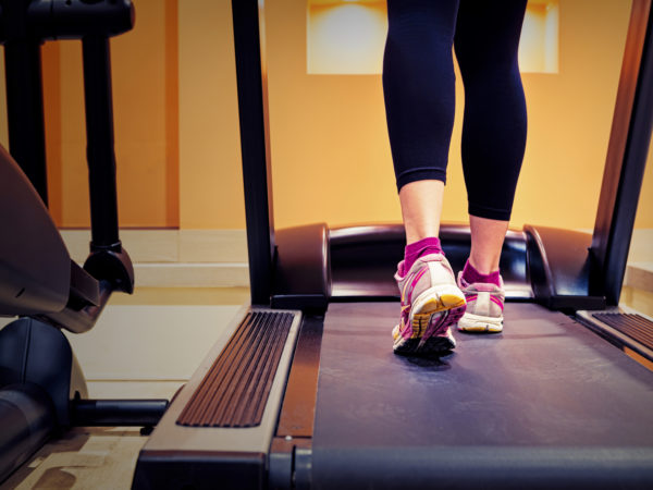 Girl running on treadmill in gym, close up. Canon 5D MK III
