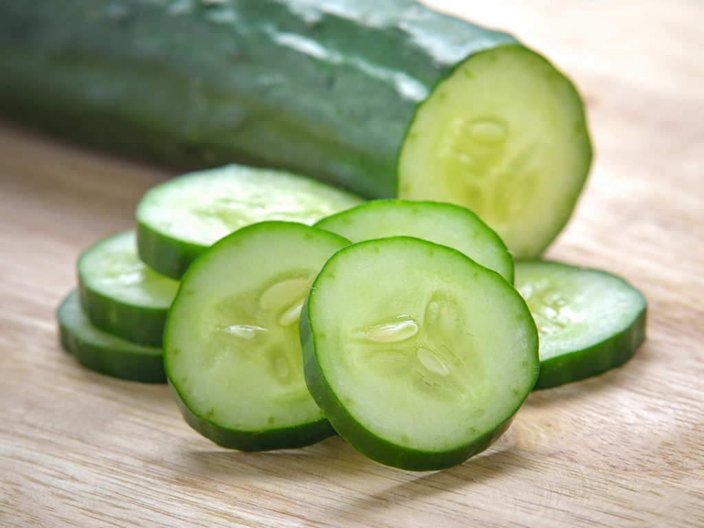 Fresh Cucumber slices on wood background