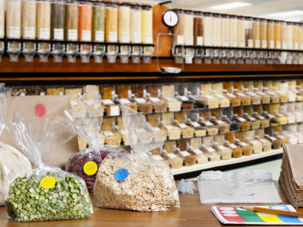 A store counter showing the packaged food and supplies needed to shop in the bulk food section of a natural food store.