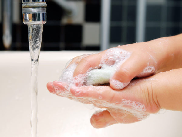 Detail of little girl washing her hands