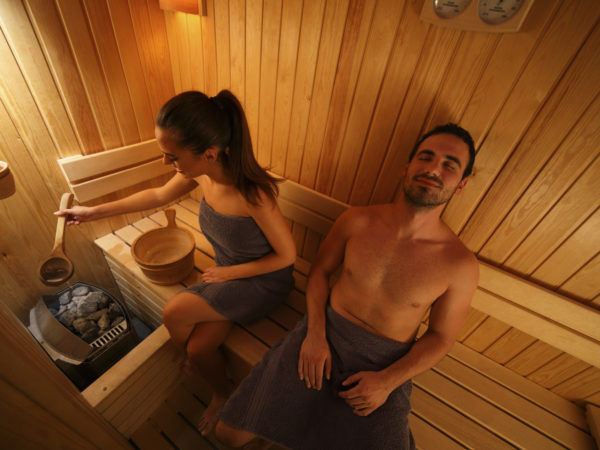 Young couple is relaxing in the sauna. High angle view.