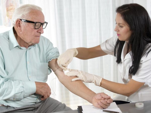 Blood sampling by an older man