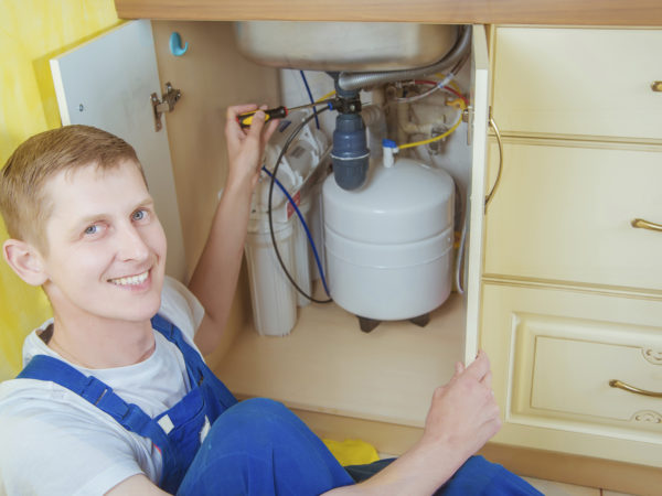 Plumber installs a water filter. water filter.