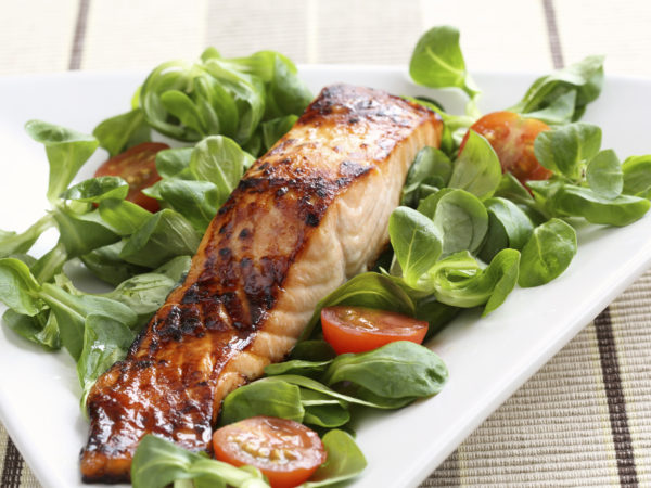 Grilled salmon with a honey glaze on a bed of lambs lettuce