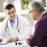 Doctor explaining prescription to senior patient, healthcare concept