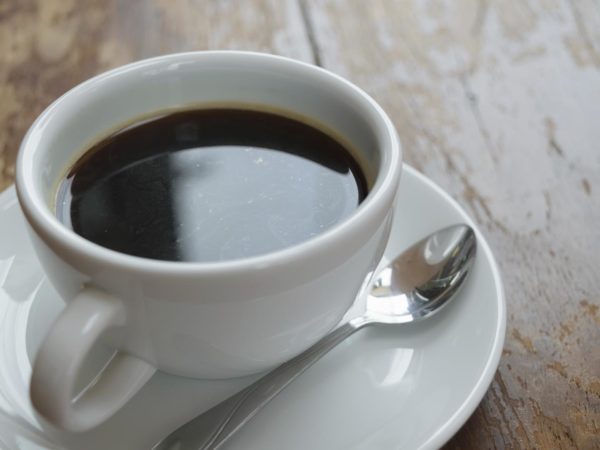 Coffee in white cup on wood table