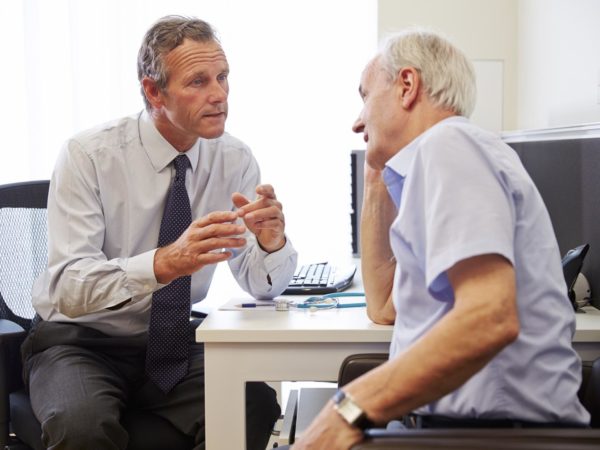 Senior Patient Having Consultation With Doctor In Office