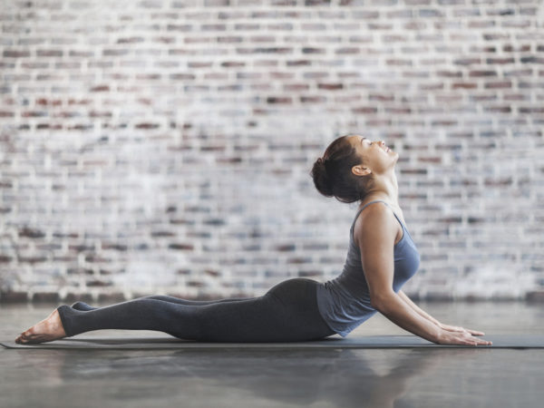 Young Woman Doing Yoga Meditation and Stretching Exercises. Stock photo.