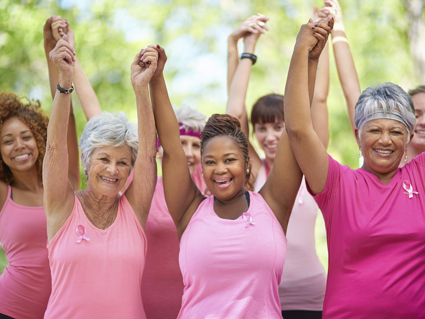 Portrait of a group of enthusiastic woman taking part in a fitness event to raise awareness for breast cancer
