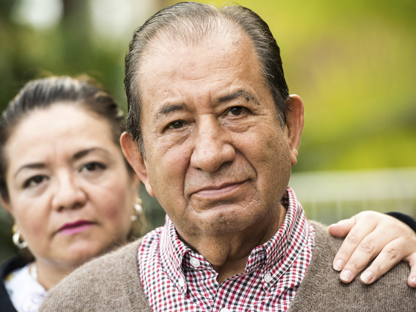 Smiling, Caring, hispanic nurse and elderly senior patient in nursing home