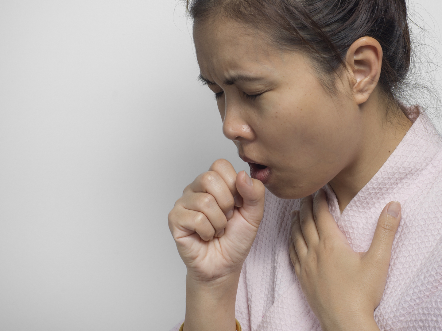 Portrait of a woman coughing