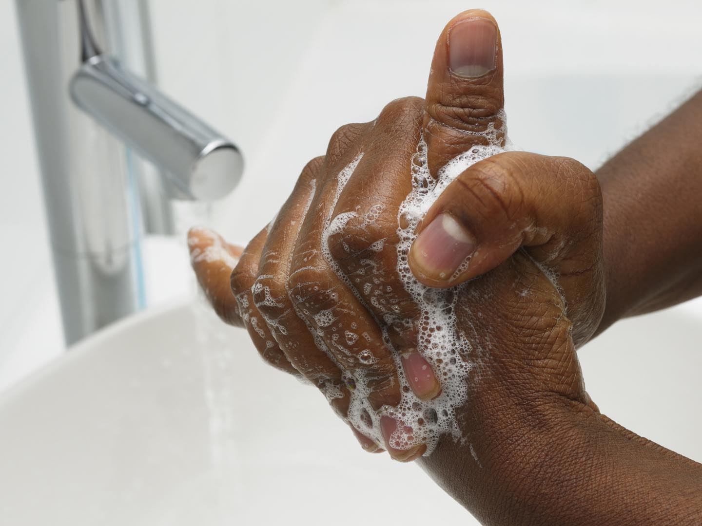 An African American hand washing.  Part of Surgical Scrub Technique for Hand Decontamination