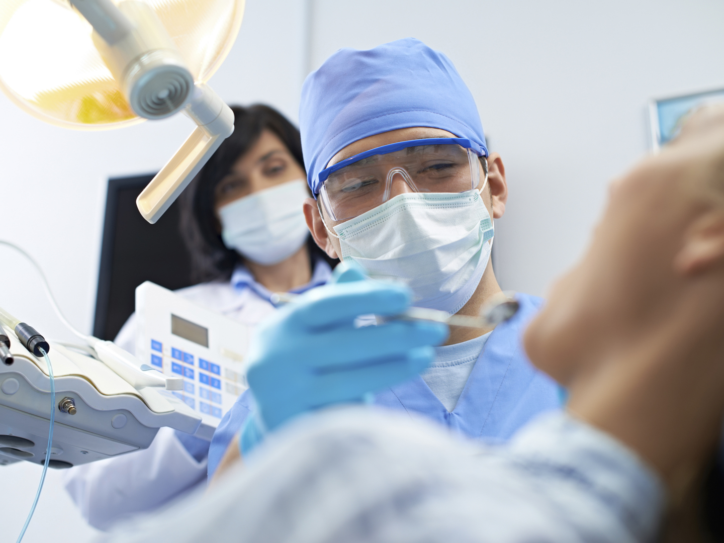 Male dentist during medical procedure at office