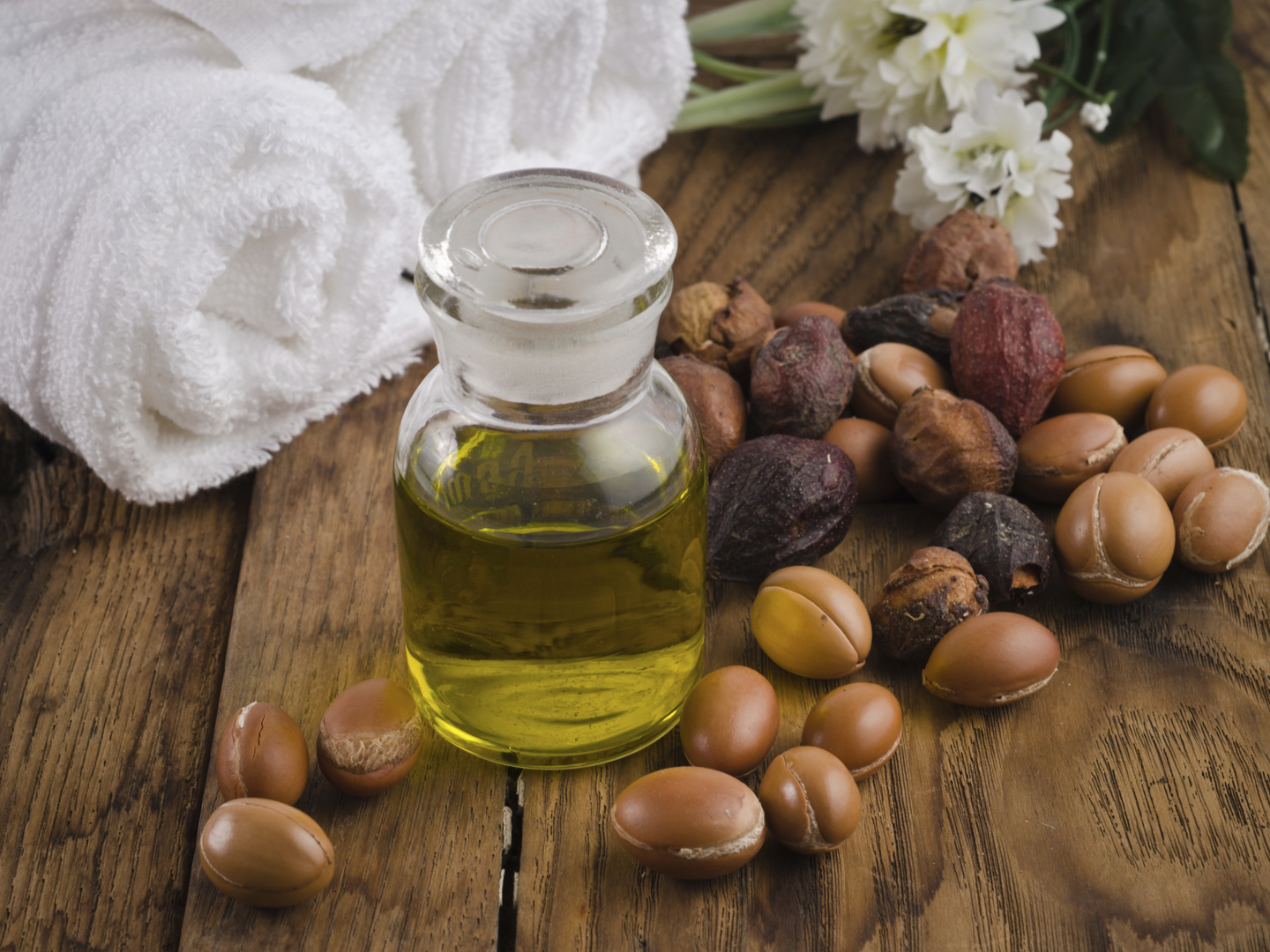 Still life of argan oil with fruit on a natural background. Argan fruits come from Morocco (Africa) and are used as component of many cosmetic products