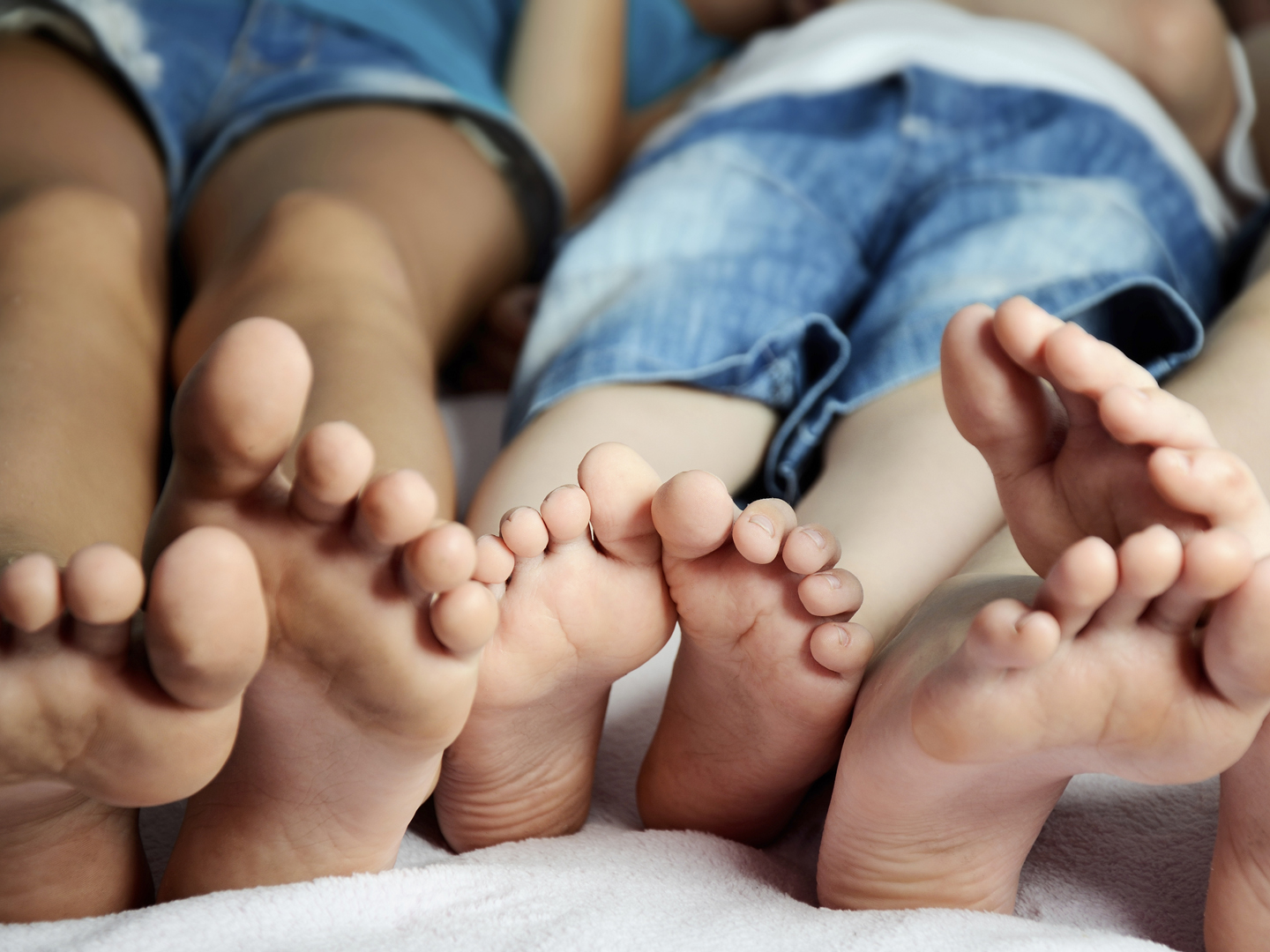 Childrens feet in bed close-up horizontal