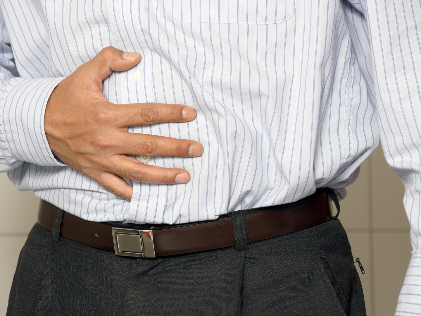 Closeup of a man having stomach pain or indigestion.