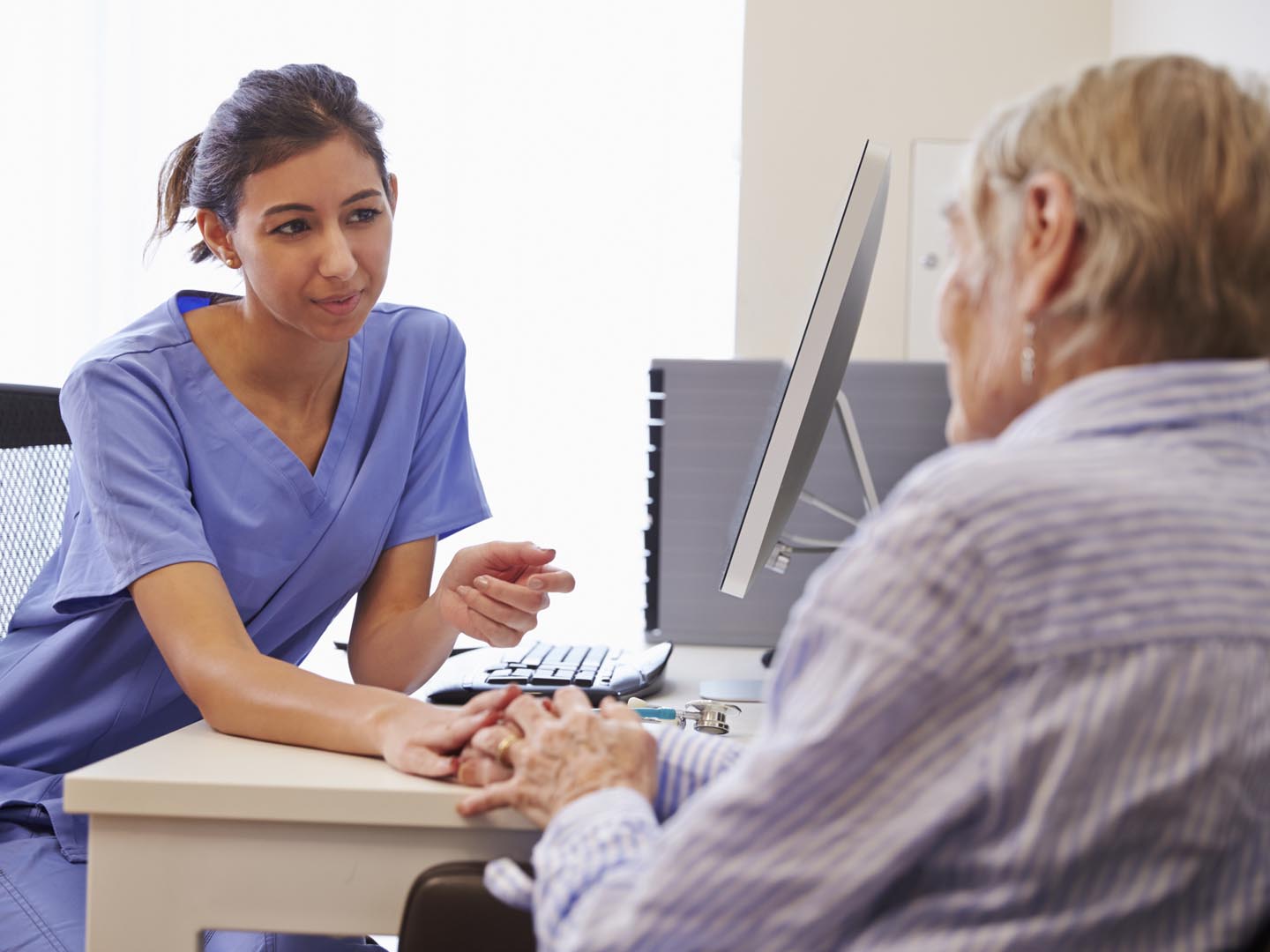 Senior Patient Having Consultation With Nurse In Office