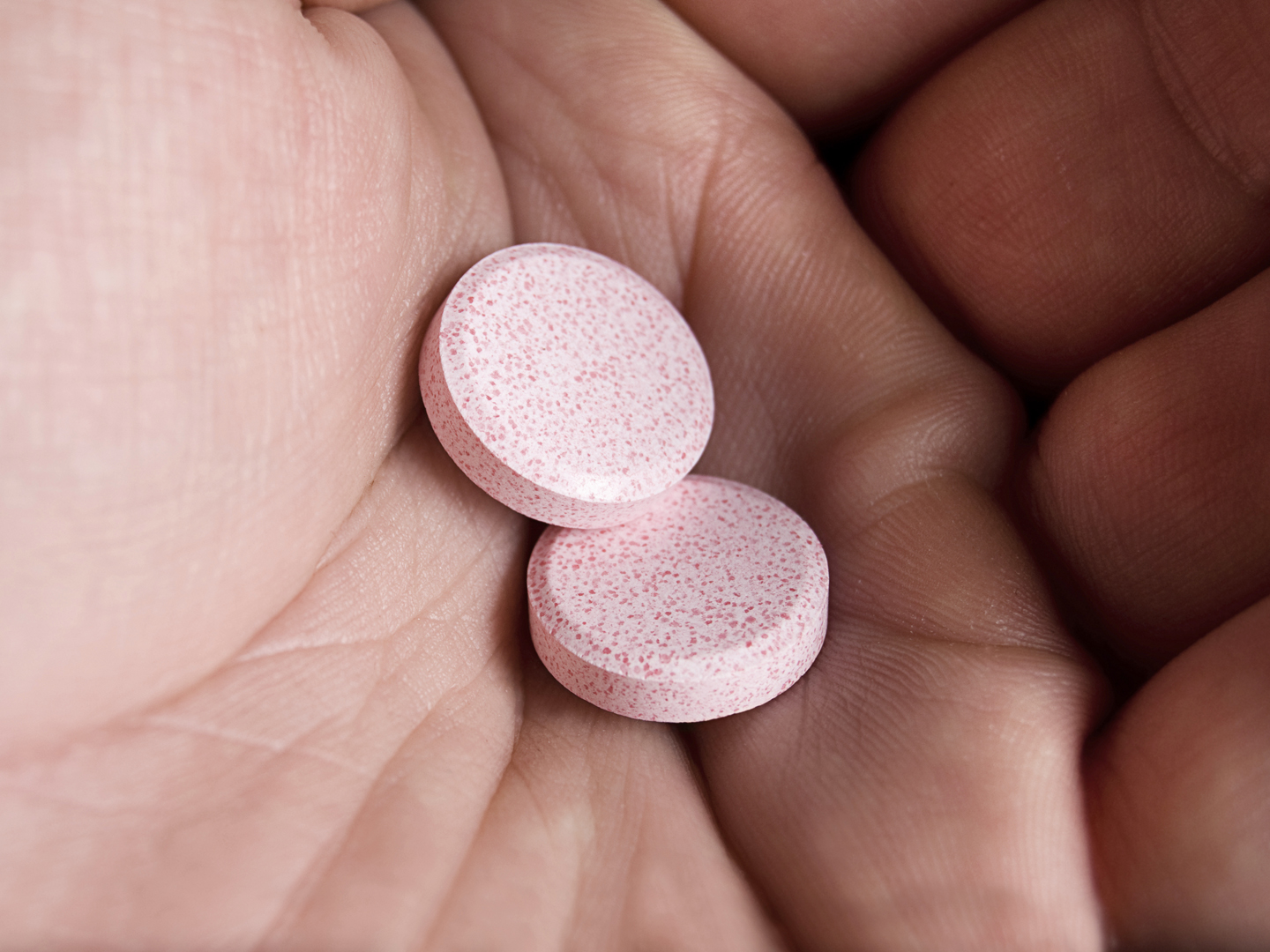 &quot;Generic antacid chewables sit in the palm of a male&#039;s hand.  Used for treatment of acid reflux, indigestion, upset stomach, and or diarrhea.  Color image, horizontal orientation.  Hard lighting for effect.&quot;