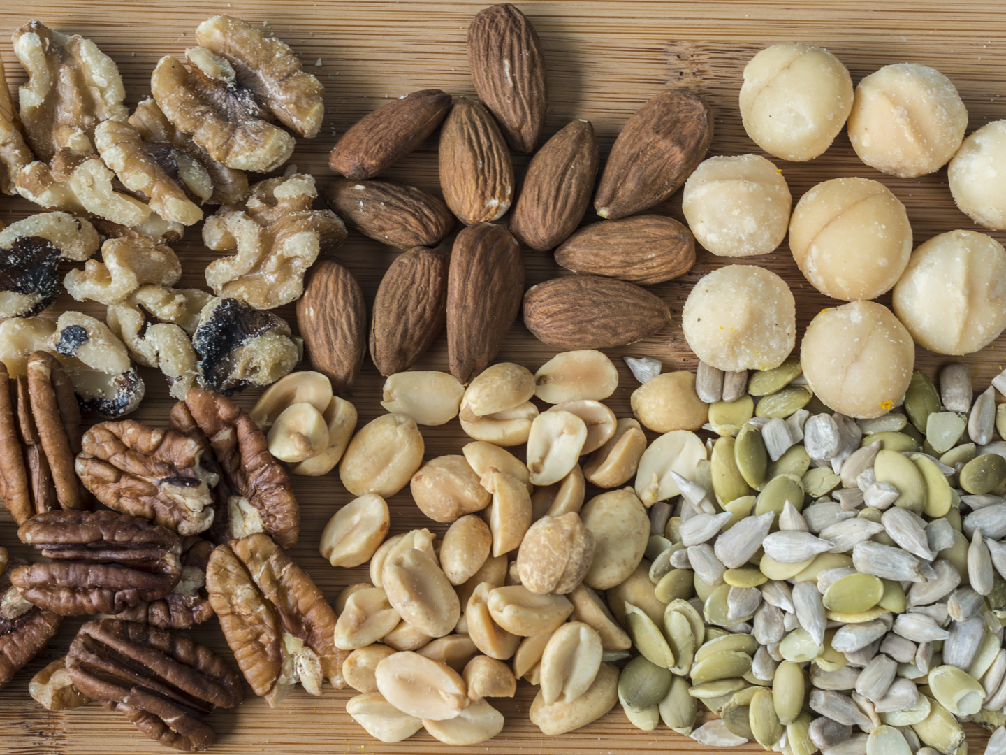 Variety of nuts and seeds on cutting board