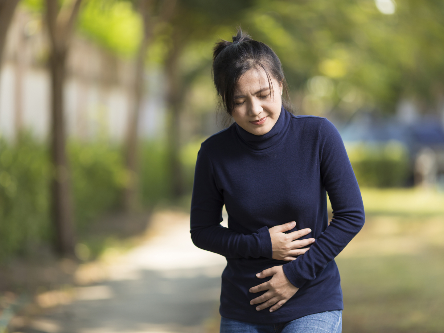 Woman Has Stomach Ache at Park