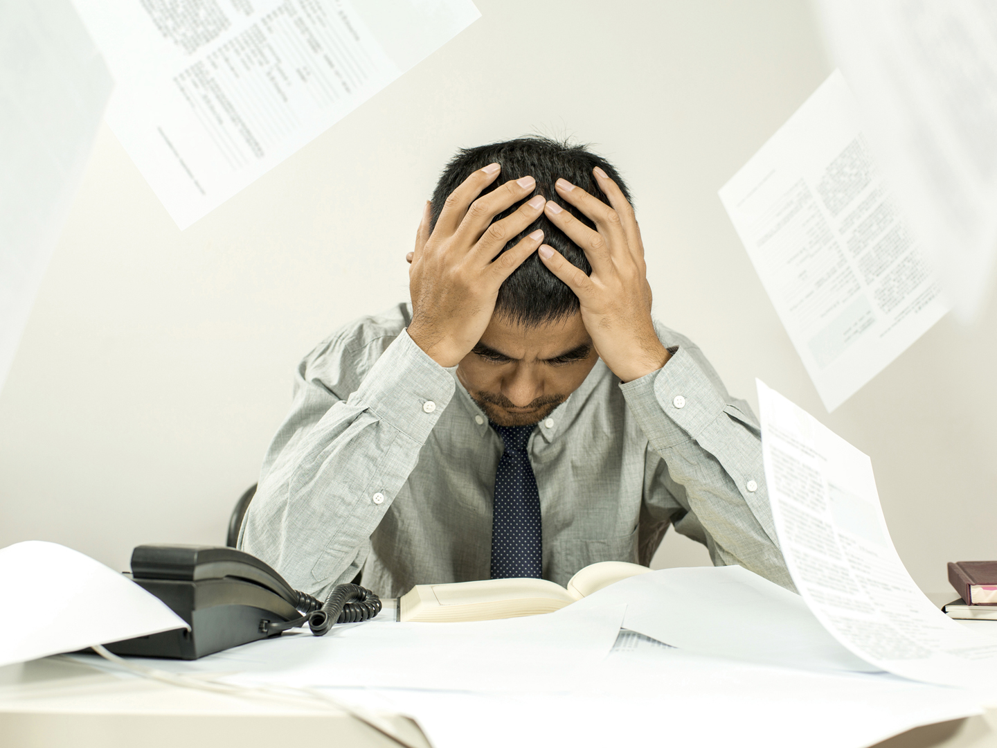 man feeling troubled with files in office