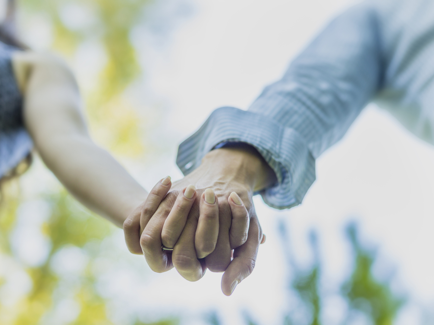 Close up on couple holding hands