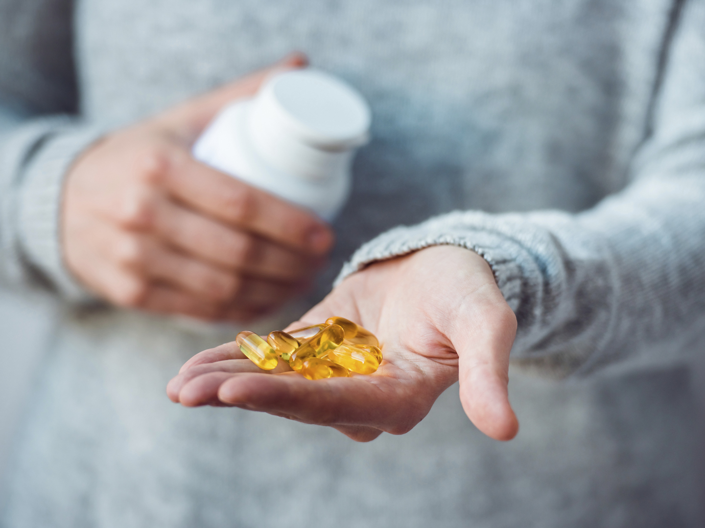 Pills in hands. Medicine and health care concept