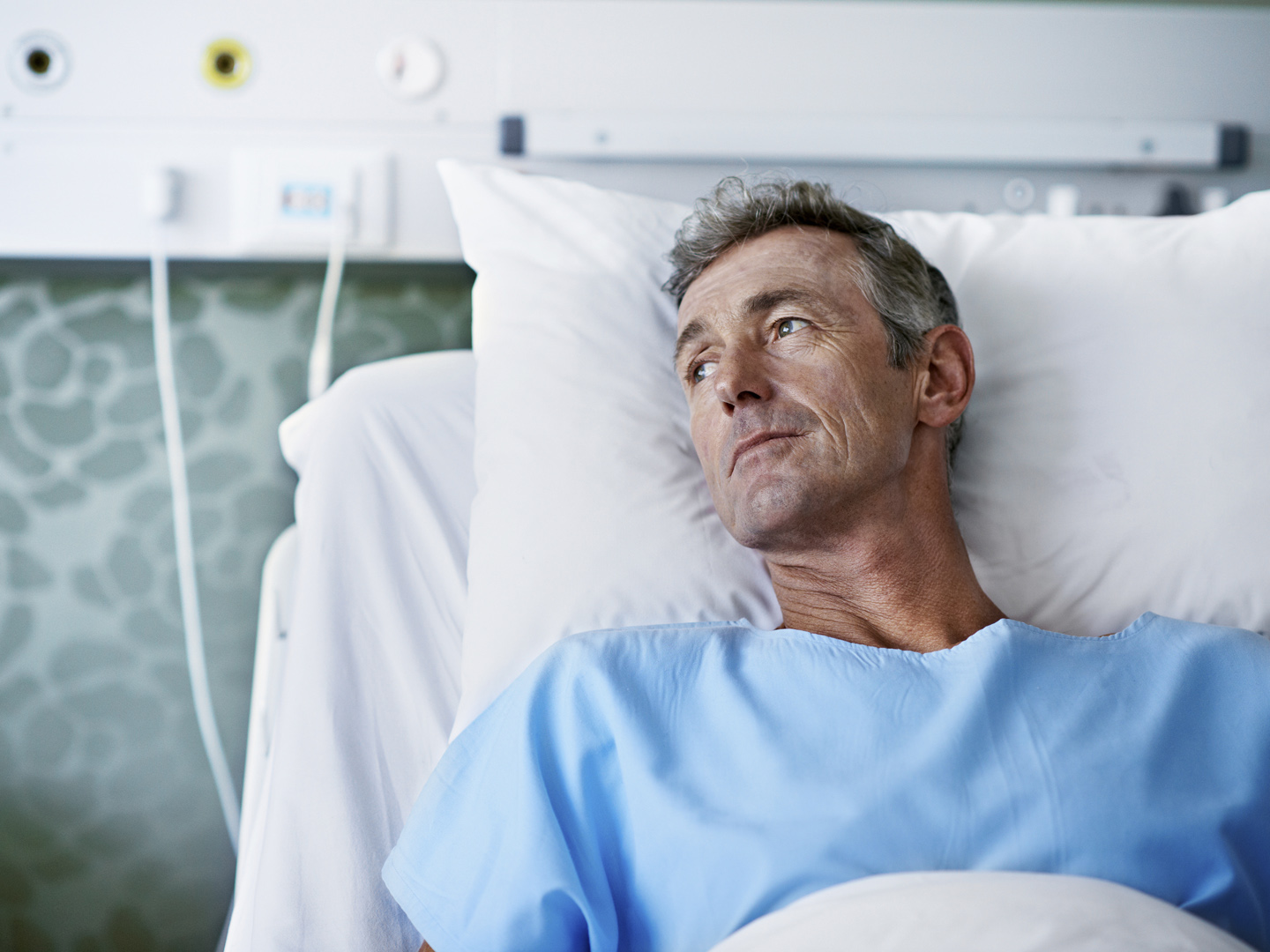 Shot of a sick man lying in a hospital bed