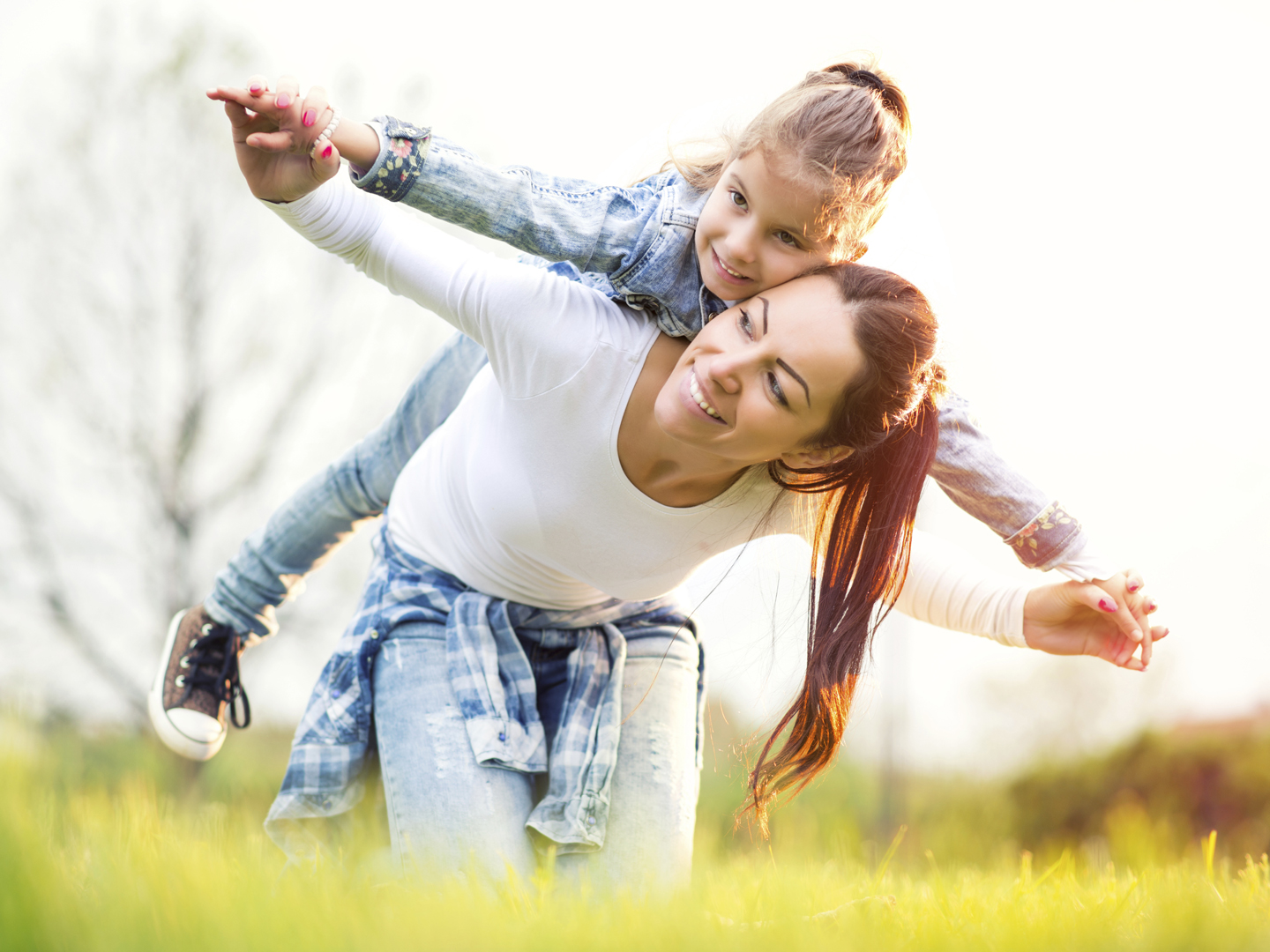 Mother with her cute little daughter relaxing together outdoor.