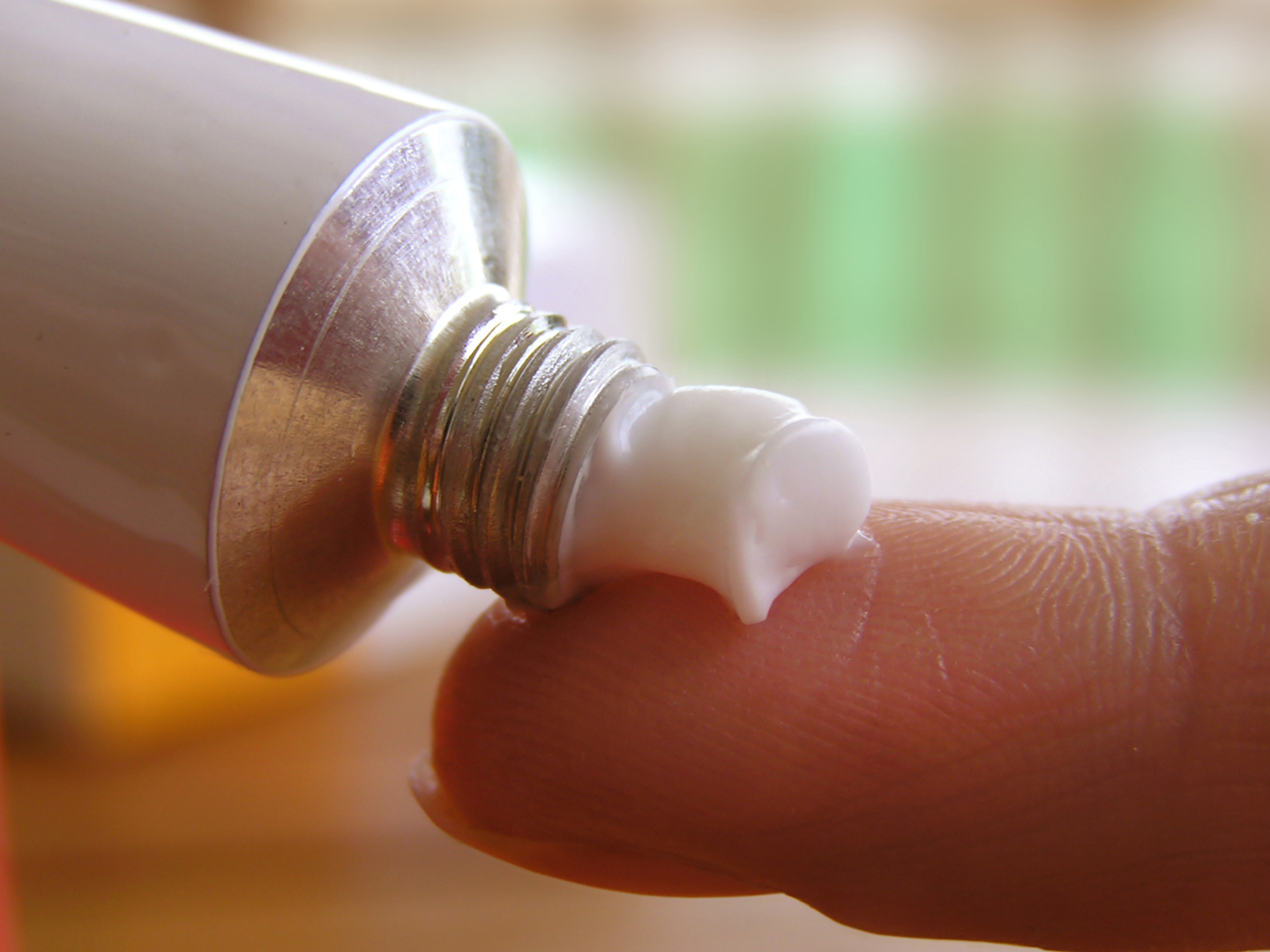 Applying some ointment on a finger.