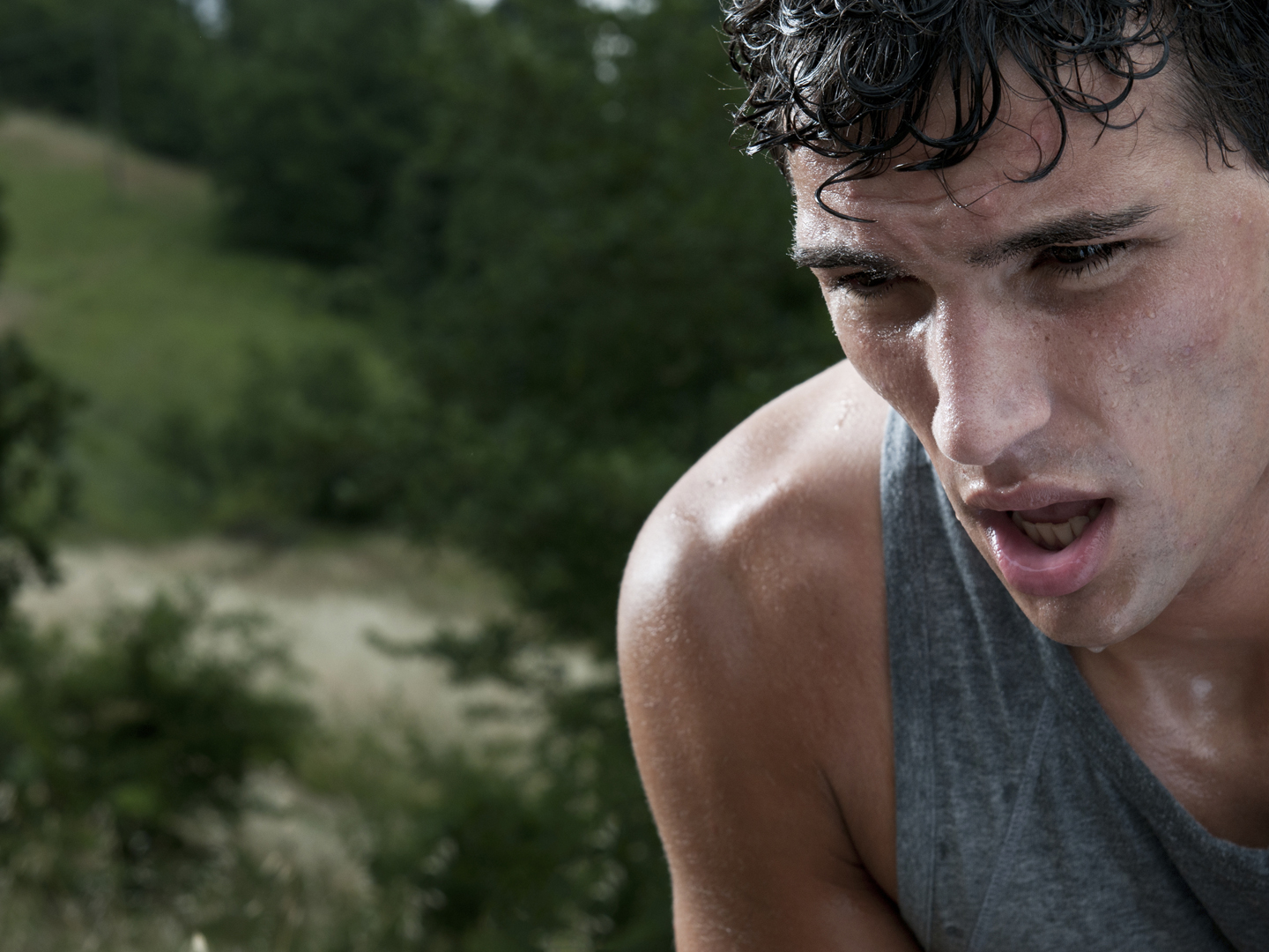 Young athletic man taking a break during a challenging jogging outdoor