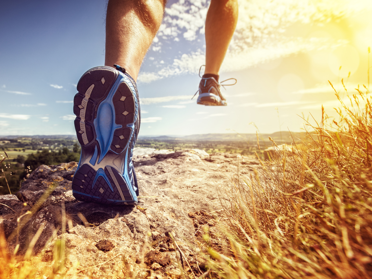 Outdoor cross-country running in summer sunshine concept for exercising, fitness and healthy lifestyle