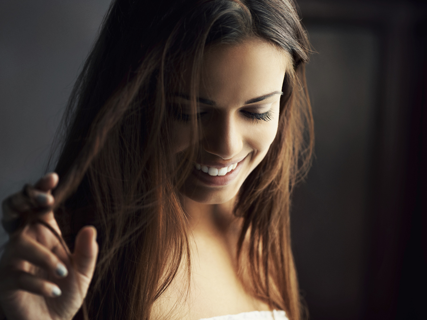 Candid shot of a sweet young woman smiling softly to herself