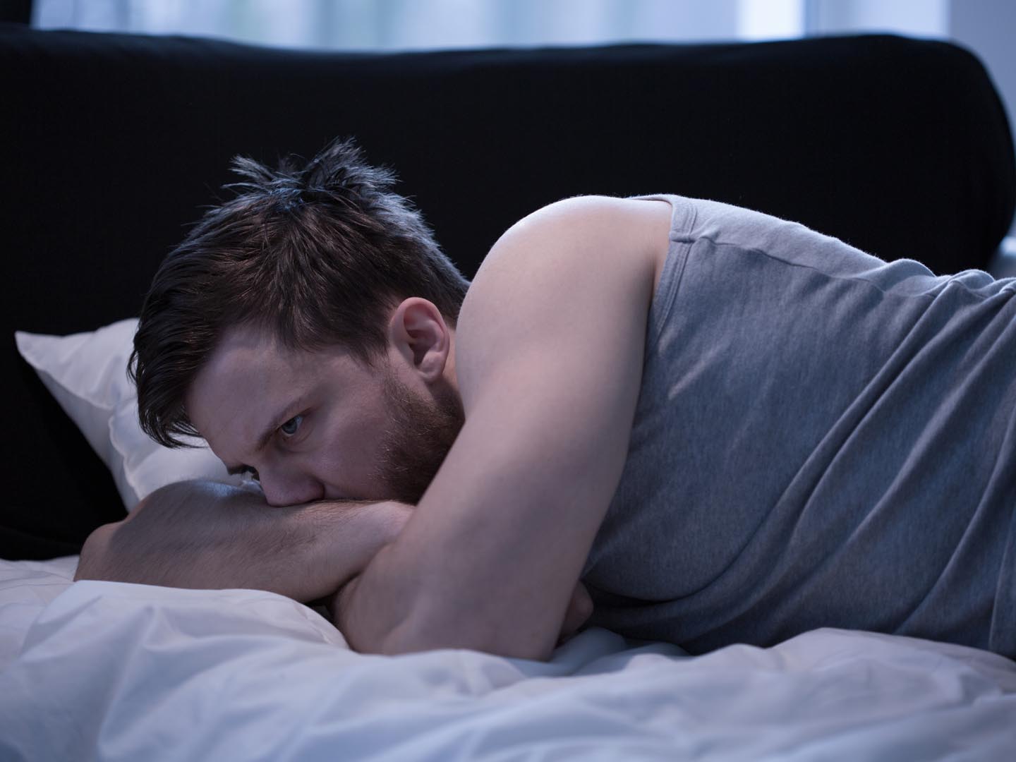 Man suffering from insomnia caused by a long air travel