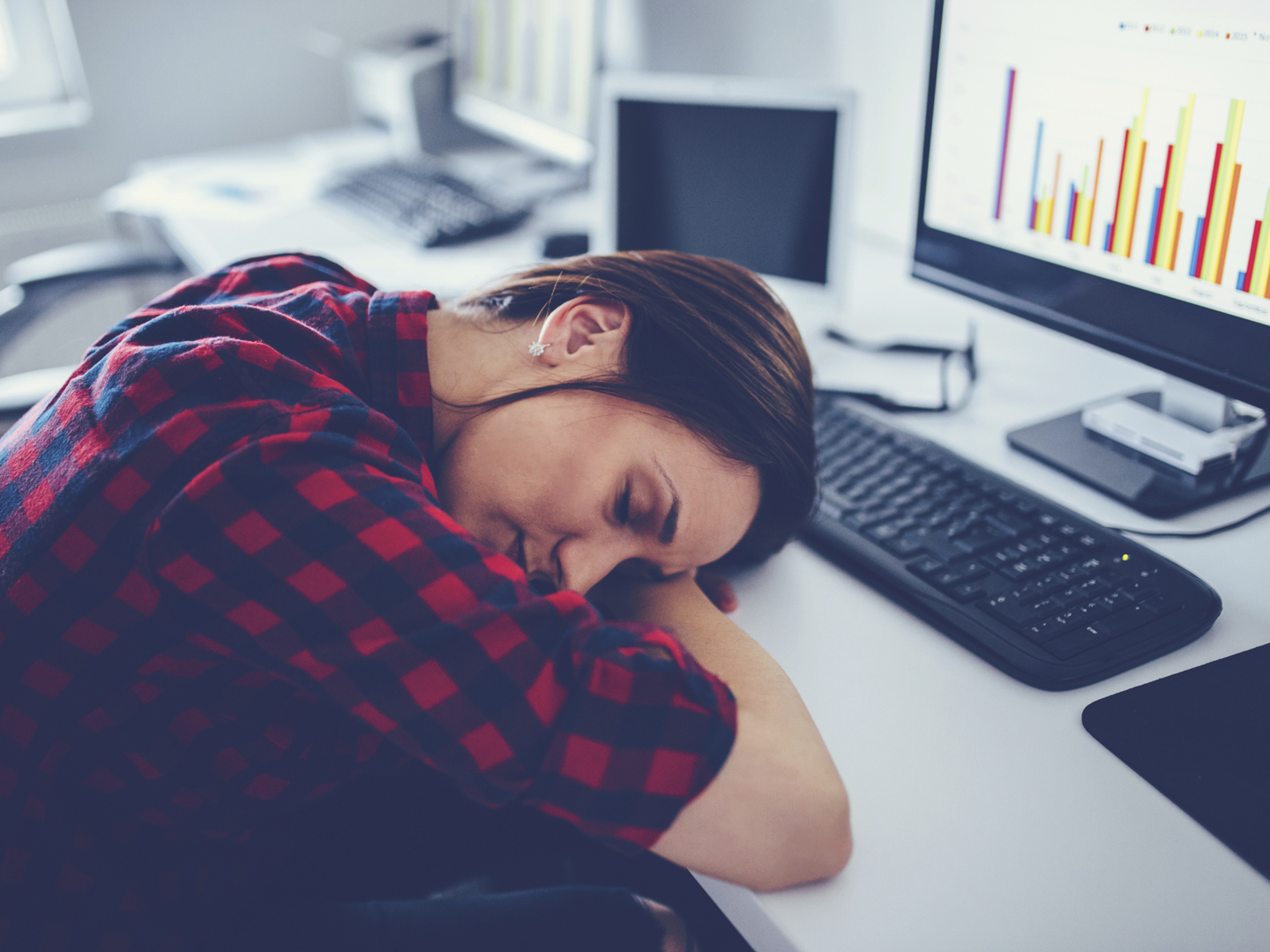 Business lady in office working hard, she is tired and she is taking a nap.