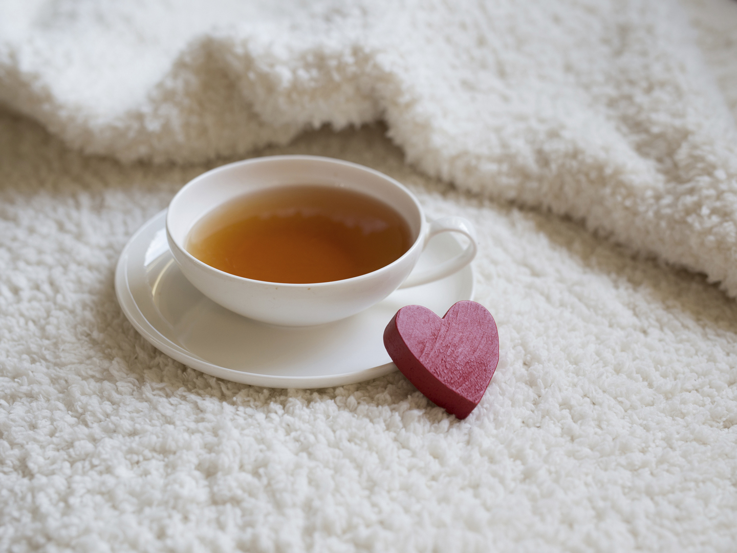 White teacup on white textile vintage texture