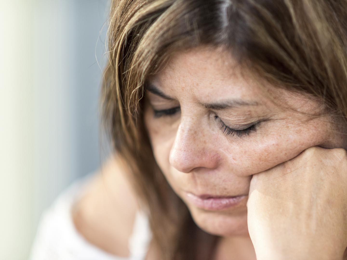 Pensive mature woman looking down